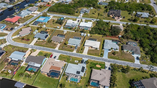 birds eye view of property with a water view and a residential view