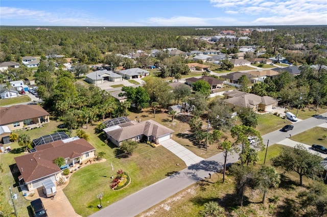 aerial view featuring a forest view and a residential view