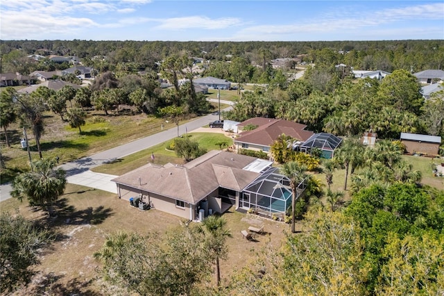 drone / aerial view featuring a view of trees