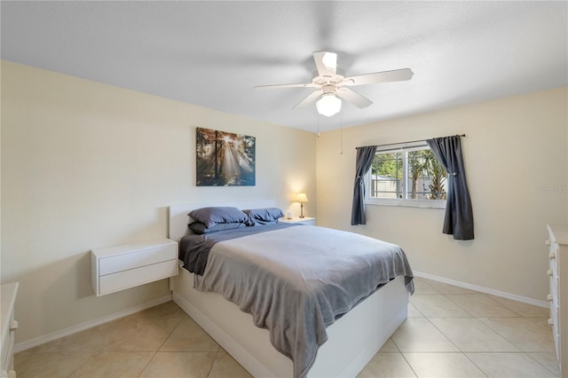 bedroom featuring light tile patterned floors, ceiling fan, and baseboards