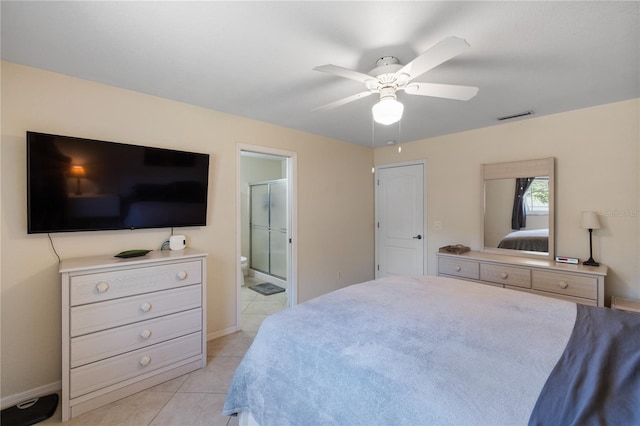 bedroom with visible vents, ensuite bathroom, a ceiling fan, light tile patterned flooring, and baseboards