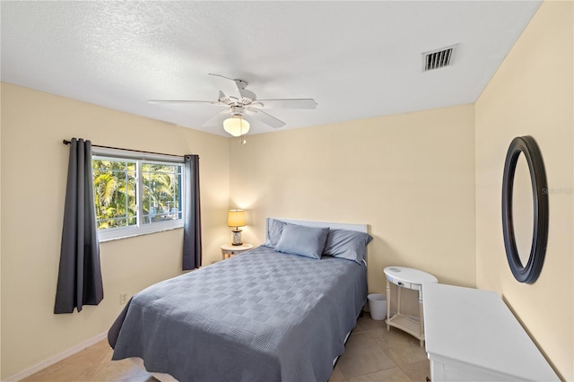 bedroom with light tile patterned floors, baseboards, visible vents, and a ceiling fan