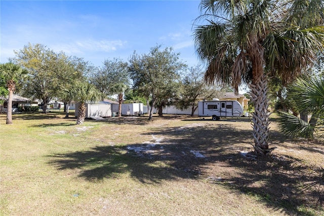 view of yard featuring a storage unit and an outdoor structure