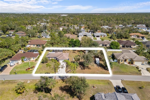 bird's eye view with a wooded view and a residential view