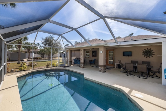 view of pool featuring a fenced in pool, outdoor dining space, glass enclosure, and a patio