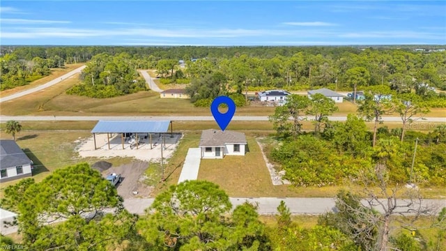 birds eye view of property with a wooded view