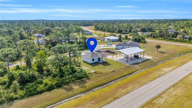 drone / aerial view with a wooded view