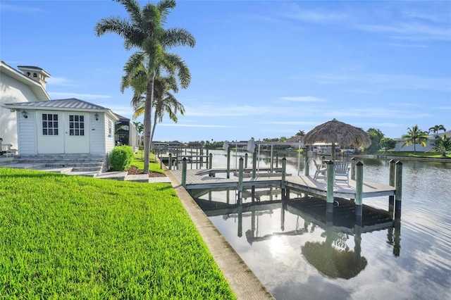 dock area with a yard, a water view, and boat lift