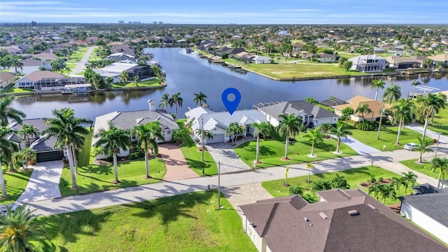 birds eye view of property with a water view and a residential view