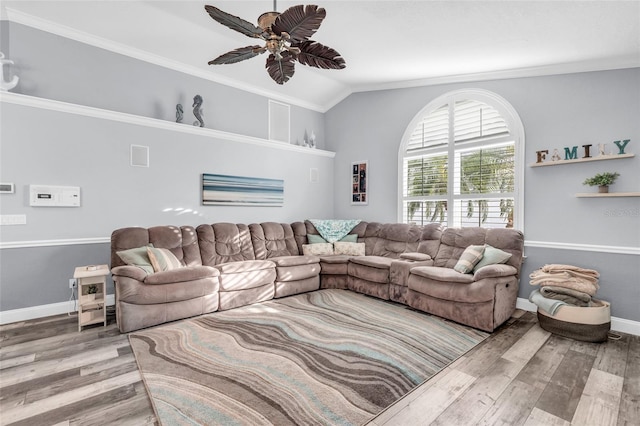 living area with baseboards, a ceiling fan, and wood finished floors