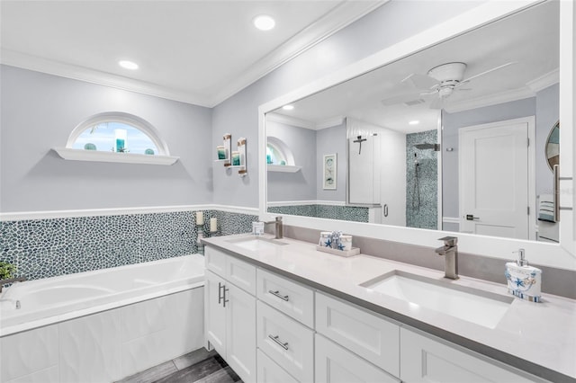 bathroom with ornamental molding, a sink, a bath, and a shower stall