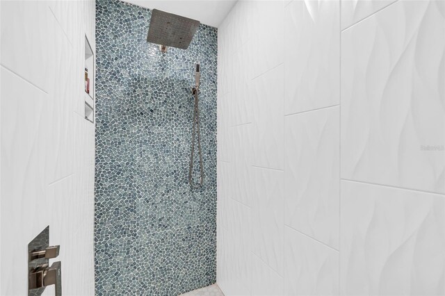 bathroom with tiled shower