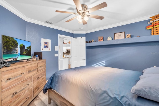 bedroom featuring a ceiling fan, wood finished floors, visible vents, and crown molding