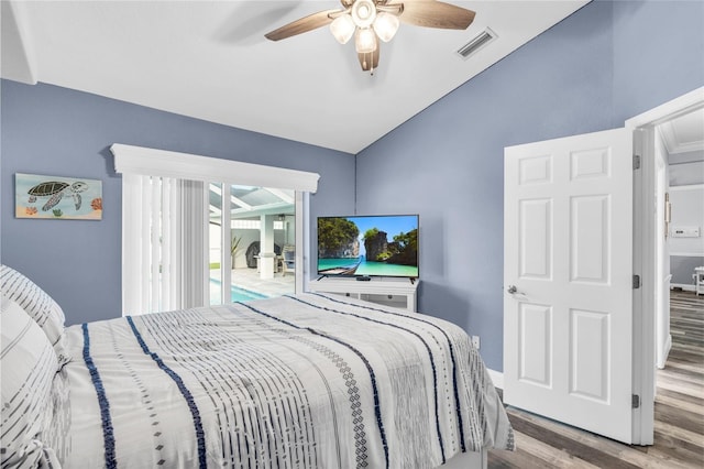 bedroom featuring lofted ceiling, access to exterior, visible vents, and wood finished floors