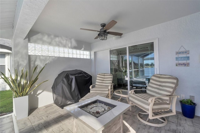 view of patio with an outdoor fire pit, a ceiling fan, and area for grilling