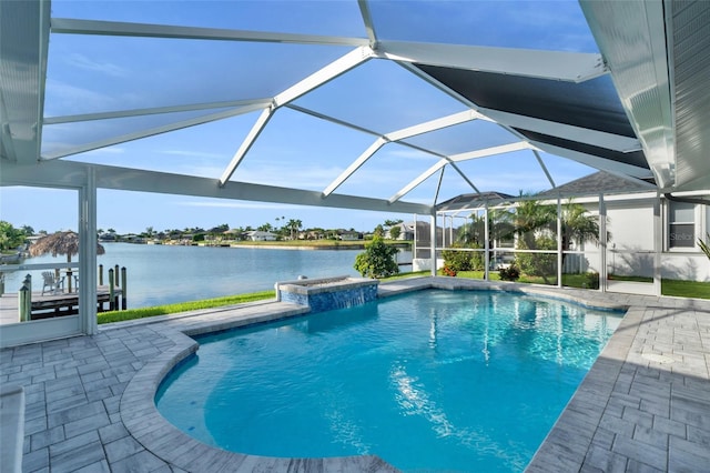 pool featuring glass enclosure, a patio area, and a water view