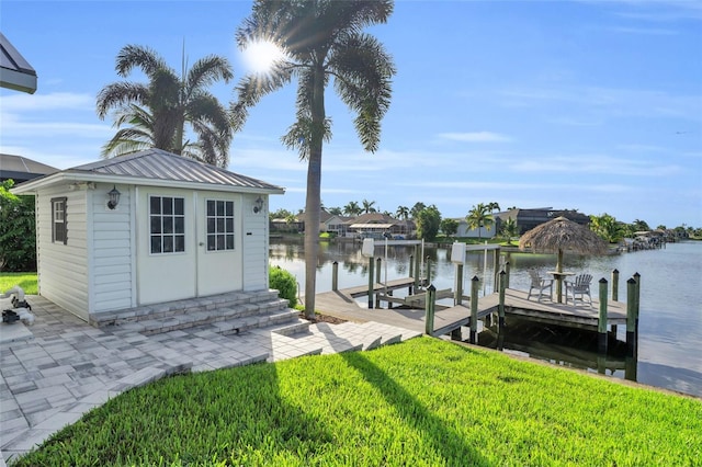 view of dock featuring a yard, a water view, and boat lift