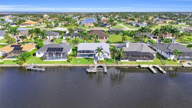 drone / aerial view featuring a water view and a residential view