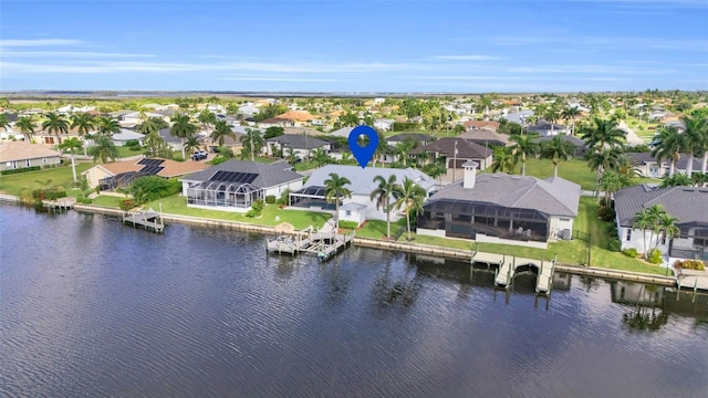 drone / aerial view with a water view and a residential view