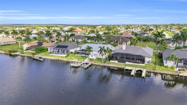 drone / aerial view featuring a residential view and a water view