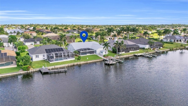 birds eye view of property with a water view and a residential view