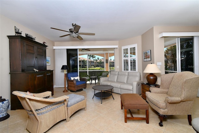 living area with light tile patterned floors, a sunroom, and a ceiling fan