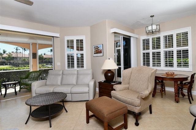 living room featuring light tile patterned floors and a notable chandelier