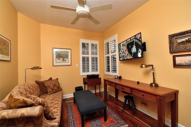 office area with ceiling fan, baseboards, and dark wood finished floors