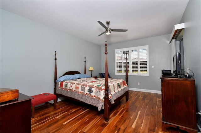 bedroom with ceiling fan, dark wood-style flooring, and baseboards