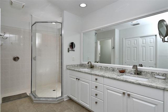 full bathroom featuring a shower stall, visible vents, and a sink