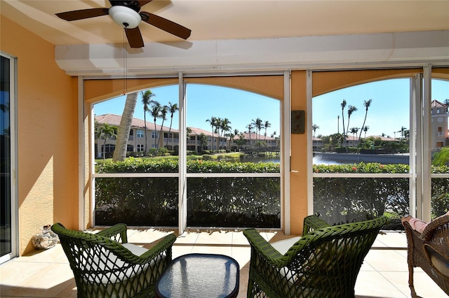 sunroom / solarium with a water view and a wealth of natural light