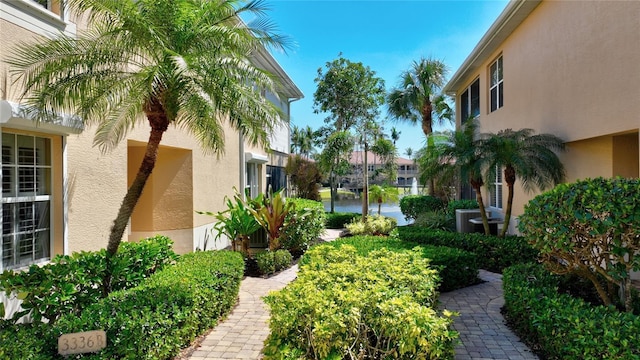 view of yard with a water view and central AC unit