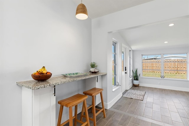 entryway with baseboards, wood finished floors, and recessed lighting