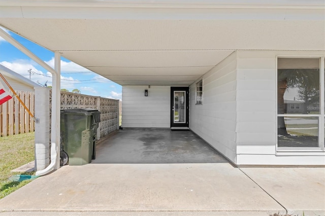 view of patio / terrace featuring an attached carport and fence