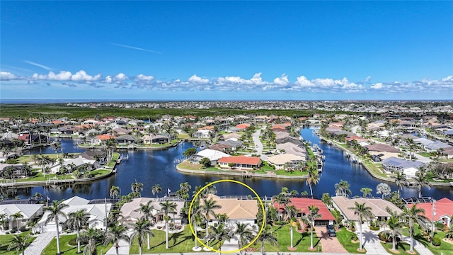 birds eye view of property featuring a water view and a residential view