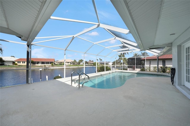 pool featuring a water view, glass enclosure, and a patio