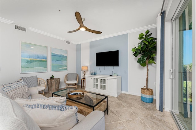 living area featuring ceiling fan, baseboards, visible vents, and crown molding