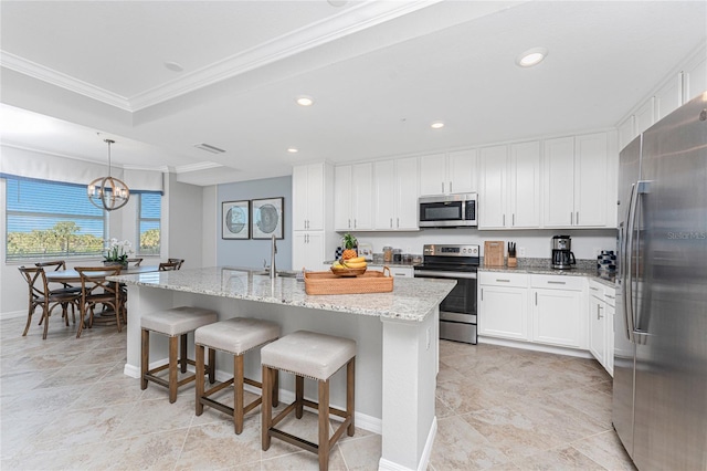 kitchen featuring an island with sink, appliances with stainless steel finishes, light stone counters, crown molding, and recessed lighting