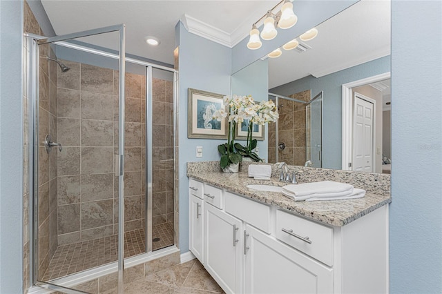 bathroom featuring a shower stall, vanity, and crown molding