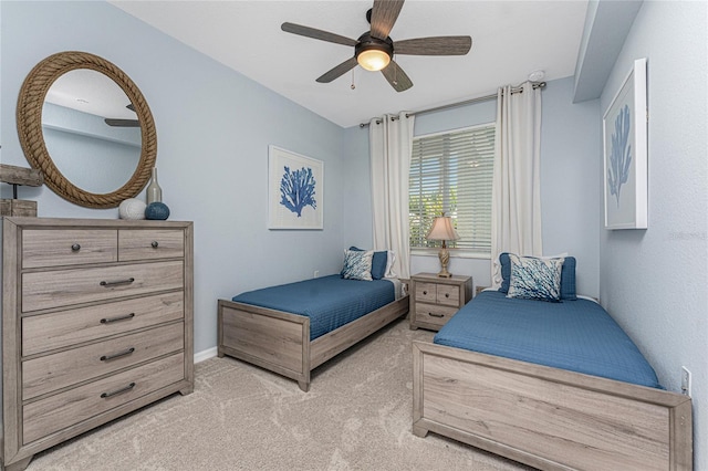 bedroom with baseboards, a ceiling fan, and light colored carpet