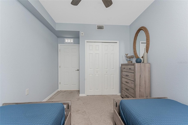 bedroom with ceiling fan, carpet floors, visible vents, baseboards, and a closet