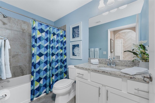 bathroom with toilet, shower / bath combo with shower curtain, and vanity