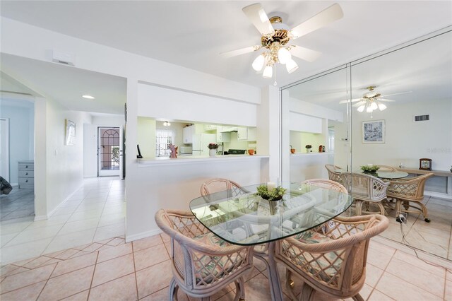 dining space with ceiling fan, baseboards, visible vents, and tile patterned floors