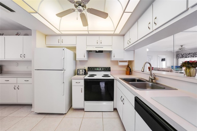 kitchen with electric range, visible vents, freestanding refrigerator, under cabinet range hood, and a sink