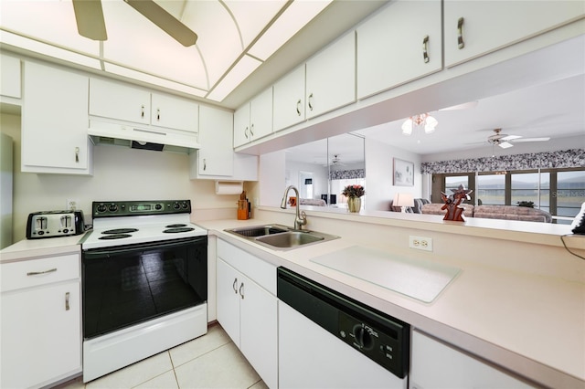 kitchen featuring dishwasher, light countertops, under cabinet range hood, a sink, and range with electric stovetop