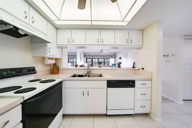 kitchen featuring light countertops, a sink, dishwasher, and electric range oven