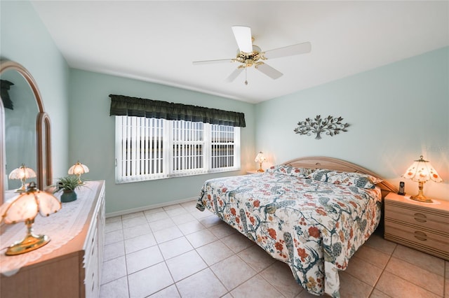 bedroom featuring light tile patterned floors, ceiling fan, and baseboards