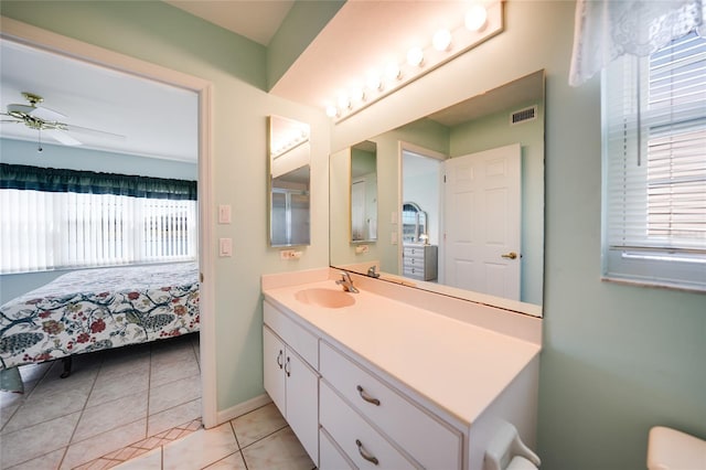 ensuite bathroom featuring ceiling fan, visible vents, a wealth of natural light, and tile patterned floors