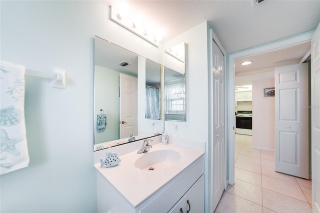 full bath featuring tile patterned flooring, visible vents, and vanity