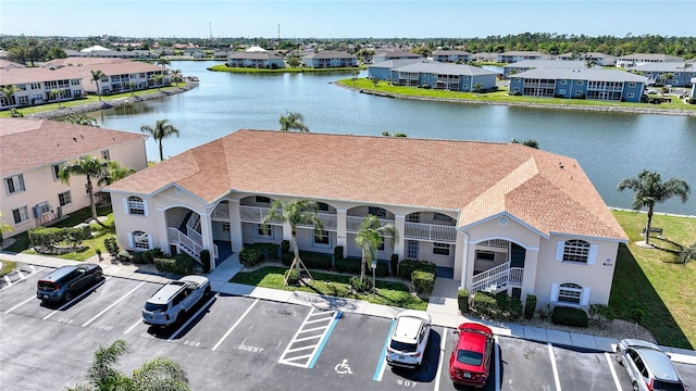 birds eye view of property with a water view and a residential view